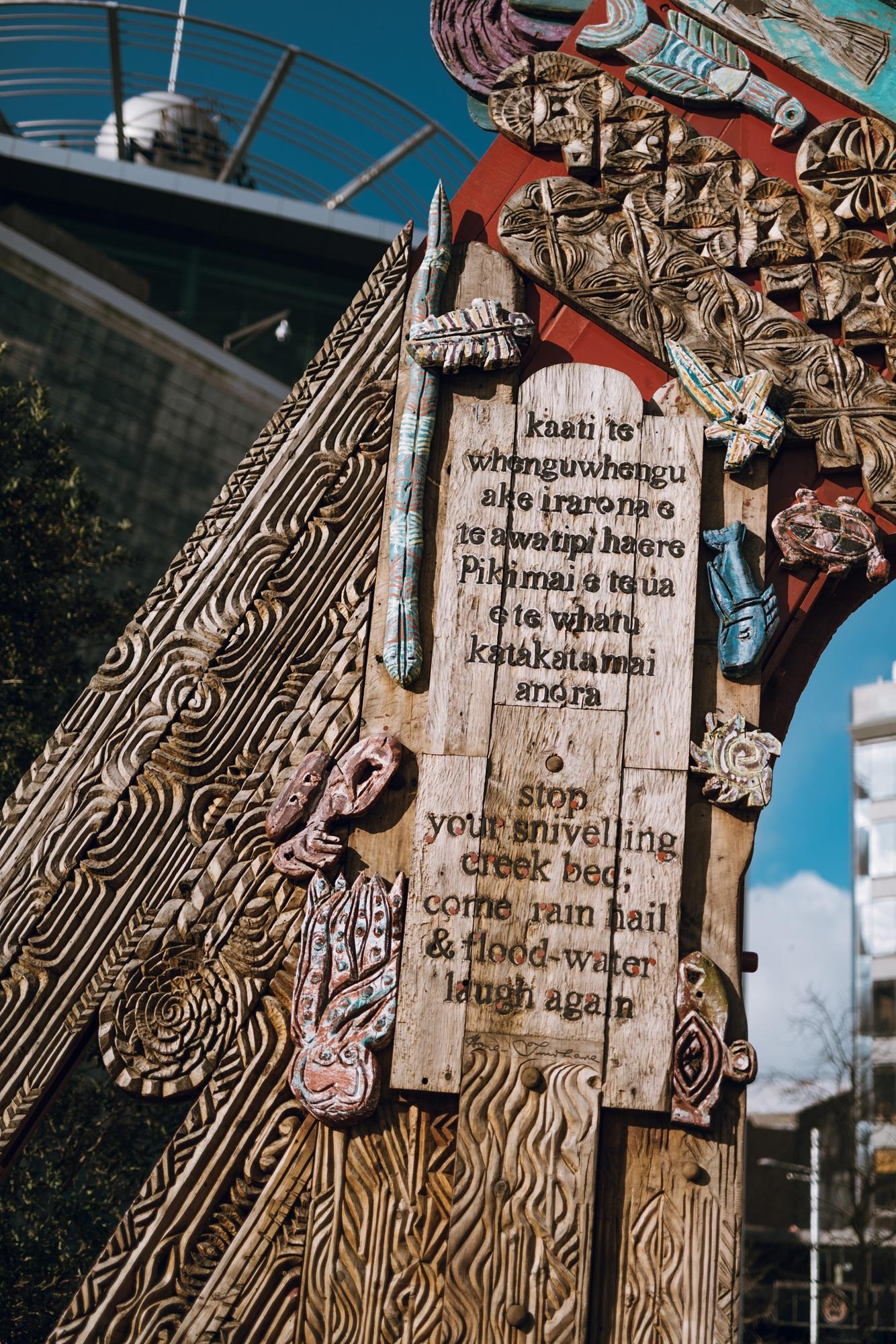Detail of poem carved on a large painted wooden waharoa (gateway) in Aotea Square