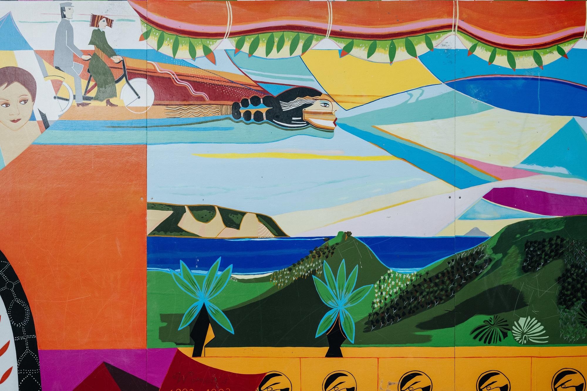 Detail view of a mural showing stylised landscape